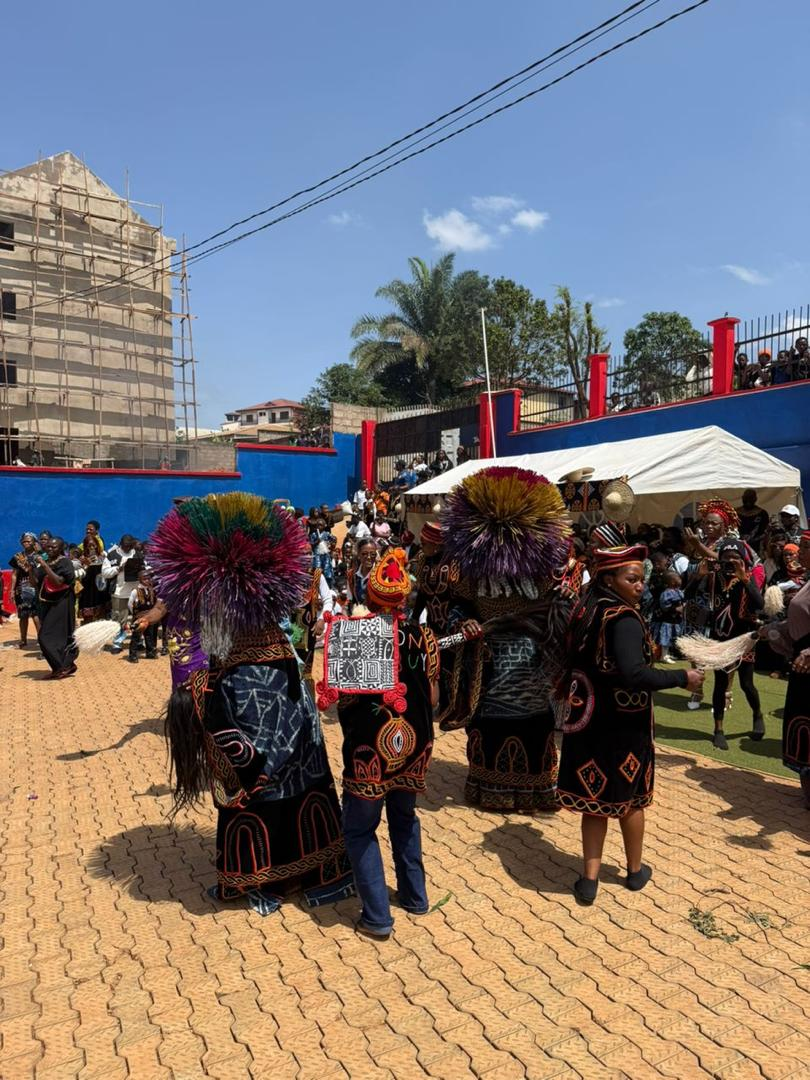 Cultural dancers in traditional regalia on the school yard