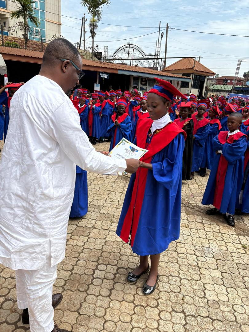 A pupil receiving her graduation certificate